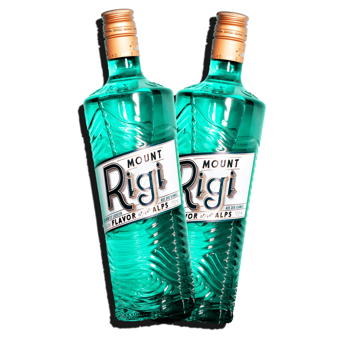 Two Mount Rigi Swiss aperitif bottles with turquoise glass shown side by side on a transparent background.